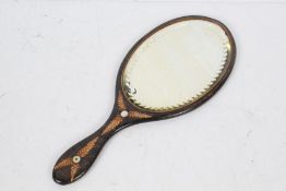 20th century folk art hand mirror, with a oval beveled glass plate the reverse decorated with a leaf
