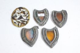 Four 19th century stain glass panels of shield form with lead mounts enclosing stained glass