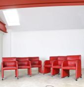 A set of six Swedish red leather armchairs, by Kinnarps, crca 1988, raised on chromed supports to