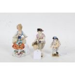 Three porcelain figures, baring marks for Dresden, Sitzendorf etc, one depicting a boy with a basket