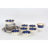 Collection of Crown Staffordshire porcelain teaware, with a blue and white ground and gilt border,