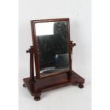 Victorian mahogany toilet mirror, with a rectangular glass plate above turned supports and raised on