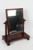 Victorian mahogany toilet mirror, with a rectangular glass plate above turned supports and raised on