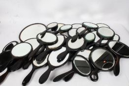 Large collection of ebonised hand mirrors and a larger hand mirror (qty)