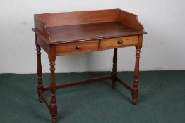 Victorian mahogany wash stand, the rectangular top with a wooden gallery above a pair of drawers