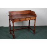 Victorian mahogany wash stand, the rectangular top with a wooden gallery above a pair of drawers