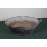 20th century galvanized metal bath, of oval form with twin handles, 121cm wide
