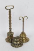 Three 19th century brass door porters, one example in the form of a lions paw, the tallest 36cm (3)