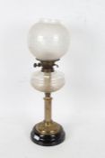 Victorian oil lamp, with a opaque glass shade above a cut glass reservoir and a brass reeded