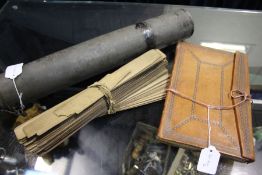 Far Eastern prayer sticks held in metal container, together with a leather bound prayer book, (2)