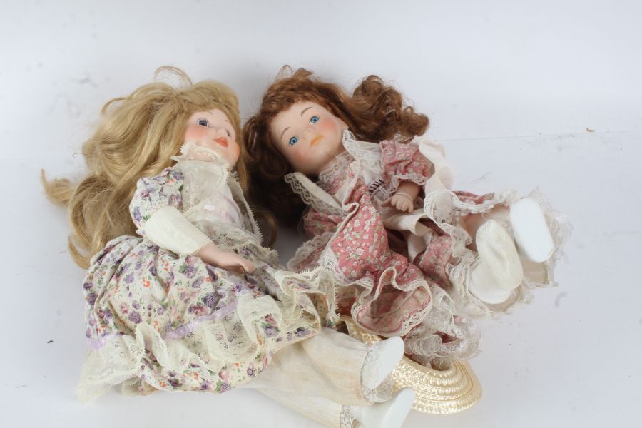 **DONATE TO CHARITY** Two porcelain headed dolls, "The Classique Collection", each with floral