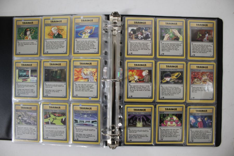 A collection of 1st Edition Gym Heroes Pokémon cards housed in a folder. To include a full non - Image 2 of 3