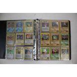 A collection of 1st Edition Gym Heroes Pokémon cards housed in a folder. To include a full non