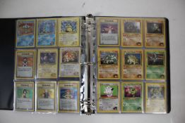 A collection of 1st Edition Gym Heroes Pokémon cards housed in a folder. To include a full non