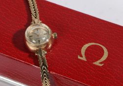 Omega 9 carat gold ladies wristwatch, the signed silver dial with baton markers, manual wound, the
