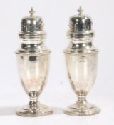 Pair of Elizabeth II silver sugar castors, Sheffield 1960, maker Walker & Hall, the scroll pierced