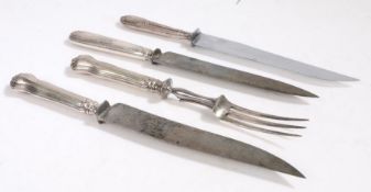 French silver handled carving knife and fork, the engine turned handles with vacant oval cartouches,