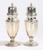 Pair of Elizabeth II silver sugar castors, Sheffield 1960, maker Walker & Hall, the scroll pierced