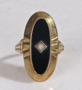 9 carat gold ring, with an oval head set with a stone and black surround, ring size O, 4.2g