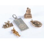 Four 9 carat gold charm bracelet charms, to include the treaty stone Limerick, locket, figure