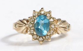 9 carat gold blue topaz and diamond ring, the head set with a claw mounted oval faceted blue topaz