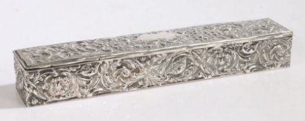 Edward VII silver dressing table box, of elongated rectangular form, the hinged lid with embossed