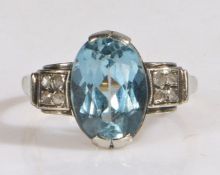 An 18 carat gold zircon and diamond set ring, with a central blue zircon and eight small diamonds,