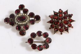 Three 19th Century brooches, the first with a pearl set centre and projecting garnets, 37mm