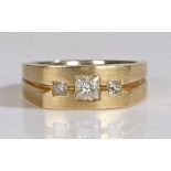 14 carat gold ring set with a central square cut diamond flanked by two smaller square cut diamonds,