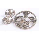 Silver brooch and earring set by David Tarrant, both depicting floral scenes, baring marks to the