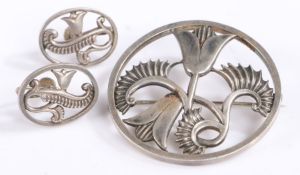 Silver brooch and earring set by David Tarrant, both depicting floral scenes, baring marks to the