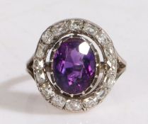 18 carat gold, amethyst and diamond set ring, with a central amethyst and a diamond surround, ring