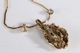 "Melting Pot" gold pendant, formed from old gold, unmarked, set on a yellow metal chain with two