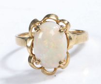 9 carat gold and white opal set ring, the head set with a large claw mounted oval white opal, ring