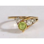 An 18 carat gold, peridot and diamond ring by Tom Payne, ring size R, 6.4 grams
