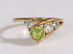 An 18 carat gold, peridot and diamond ring by Tom Payne, ring size R, 6.4 grams