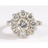 18 carat white gold and diamond cluster ring, set with a central brilliant cut diamond surrounded by