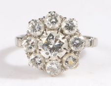 18 carat white gold and diamond cluster ring, set with a central brilliant cut diamond surrounded by