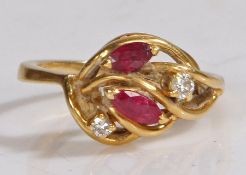 18 carat gold diamond and ruby ring, the head set with two claw mounted round cut diamonds and two
