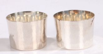 Pair of Elizabeth II silver cups, London 1976, maker RDA, with beaten flared bodies, the bases dated
