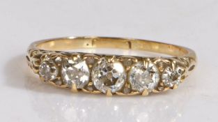 A five stone diamond ring, set with a graduated row of old brilliant cut diamonds and carved