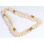 Large pearl and yellow metal necklace, formed of spherical pearls with unmarked yellow metal mounts,