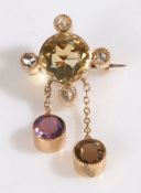 18 carat brooch, set with a central citrine with diamond surround and two amethyst drops, 17mm wide,