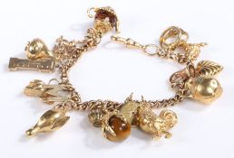 9 carat gold charm bracelet set with sixteen charms, to include an eagles claw clasping a ball of