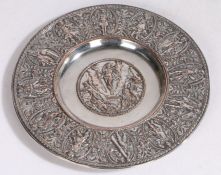 An Elkington plate paten, the central field and border with embossed depictions of classical