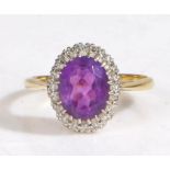 18 carat gold diamond and amethyst ring, the head set with a oval faceted stone surrounded by