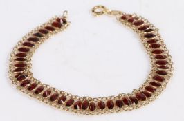 9 carat gold and garnet bracelet, the bracelet formed of oval garnets on a gold chain, 18cm long,