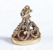 19th century yellow metal and cornelian pendant seal, the body decorated with a floral scroll design