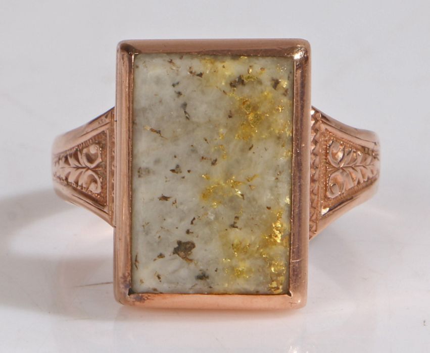 A 19th Century 15 carat gold poison ring, with an hardstone hinged head on wide tapering