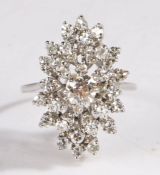 Diamond cluster ring, the round cut diamonds set to a spray design, the central diamond